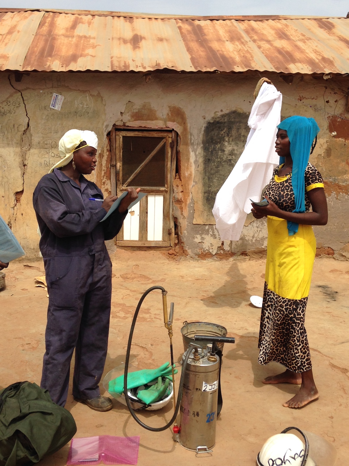 Female spray operator collecting household information