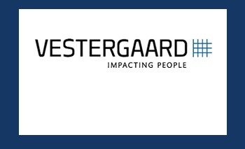 The word Vestergaard in all capital letters in black with a light blue net/hashtag image at the end. The words Impacting People are in small, all capital letters under the word Vestergaard. The image is on white with a dark blue border.